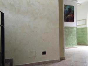 a room with a wall with a painting on it at Hotel Martin in Volpiano +21 photos