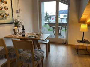 a dining room with a table with wine glasses on it at Holiday apartment Freiberg in Oberstdorf +5 photos