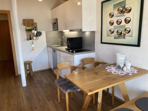 a kitchen and dining room with a wooden table and chairs at Holiday apartment Freiberg in Oberstdorf
