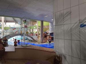 a pool in a mall with people in a swimming pool at "thousand lakes" Comfortable holiday residence in Marienfelde