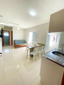 a kitchen and dining room with a table and chairs at Pousada Gomes in Florianópolis +36 photos