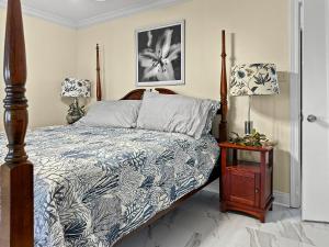 a bedroom with a bed with a blue and white comforter at Baywatch Paradice Bayfront, private pier, Sleeps 8 Fenced Dog Area 8 m to beach in Gulf Shores