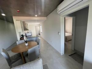 a room with a table and chairs and a bedroom at Dpto Edificio Marlin Luque in Luque