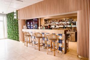 a bar with chairs and a man sitting at a counter at Grand Hotel & Casino in Port Vila