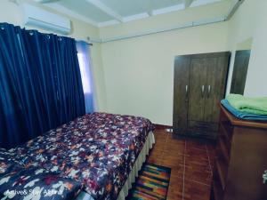 a bedroom with a bed and a dresser at Arrive and Stay in Dabadie +5 photos