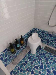 a bathroom with a toilet in a blue and white tile floor at Sea Shell Kawazu House in Kawazu +28 photos