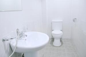 a white bathroom with a toilet and a sink at Seoul Dalbit Dongdaemun Guesthouse in Seoul