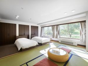 Postel nebo postele na pokoji v ubytování Hakuba Alps Hotel + 37 fotografií