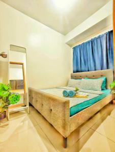 a bedroom with a bed with a mirror and a window at Shore 3 Tower 1 MOA Pasay F Suite Staycation in Manila