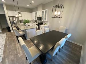 a kitchen and dining room with a table and chairs at Hidden Gem - Gated Community & Garage Parking in Houston