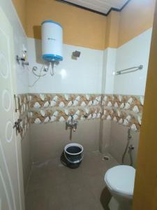 a bathroom with a sink and a toilet in a room at Prestige nature homestay in Avathi