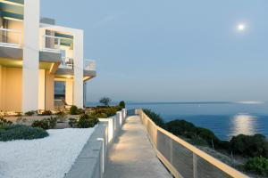 a building with a view of the ocean at Monolia Maisonettes in Monolia