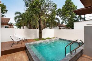 a swimming pool in the backyard of a house at Nariya Bayfront Phuket in Ban Bang Chak