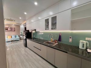 a kitchen with a sink and a refrigerator at Cat Ba Seoul 2 Hotel & Apartment in Cat Ba