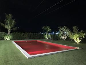 a red pool in a field at night at White Lagoon in Hua Hin