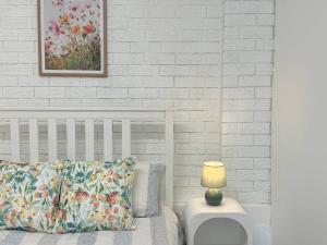 a bed with a pillow and a lamp on a table at Macgregor 2bed studio 3ELC in Brisbane +8 photos