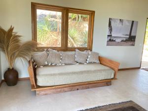 a couch in a living room with a window at Rote Island Lodge in Nembrala