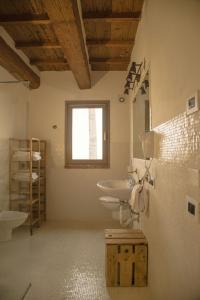 a bathroom with two sinks and a mirror at Agriturismo Ferrara Chalet in Vigarano Mainarda