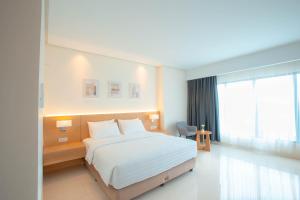 a hotel room with a bed and a window at Hilani Boutique Hotel in Luengbata +7 photos