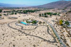 an aerial view of a road in the desert at Ranch House with Lap Pool Biking & Running Course in Desert Hot Springs +34 photos