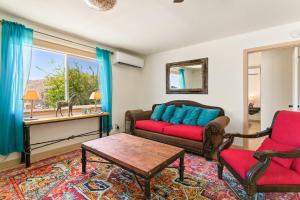 a living room with a couch and a table at Ranch House with Lap Pool Biking & Running Course in Desert Hot Springs