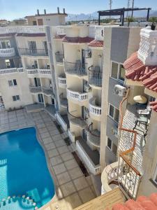 an aerial view of an apartment building with a swimming pool at The Rooftop - Amazing apartment - Sea view - Pool - Penthouse -Jacuzzi - Sharm el Sheikh in Sharm El Sheikh