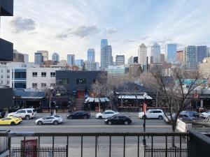 a parking lot with cars parked in front of a city at Cozy 2 Bedroom Condo with Parking in Calgary