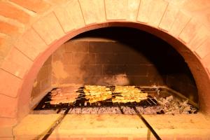 a large brick oven with a bunch of food at Ferah Hotel in Patara