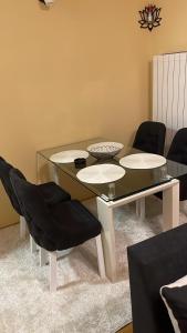 a dining room with a glass table and chairs at Apartman Bella vita 2 in Zlatibor