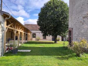 a house with a tree in the yard at Manoir Saint Joseph Colombier in Sens