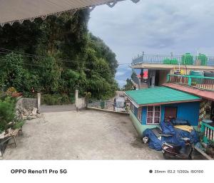 a view of a house with a motorcycle parked next to it at Rishop Mountain Homestay in Rishop
