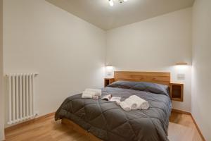 a bedroom with a bed with two towels on it at The Lovely Nest - Happy Rentals in Bardonecchia