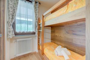 a bunk bed in a room with a window at The Lovely Nest - Happy Rentals in Bardonecchia