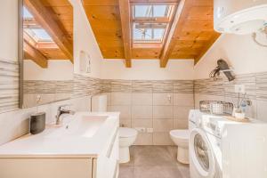 a bathroom with a sink and a washing machine at Stazione a 200m - Centro - Easy Parma Stay in Parma