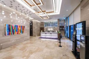 a lobby of a building with a store at Ramada Encore by Wyndham Busan Station in Busan +84 photos