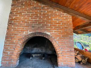 a brick oven with a fire inside of it at Vila Starcevic in Pale
