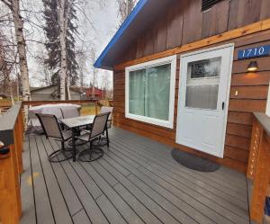 a cabin with a table and chairs on a deck at Alaskan Pipeline Place in Fairbanks