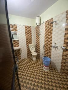 a bathroom with a toilet and a sink and a shower at New Hotel Blue Moon in Jaipur +19 photos