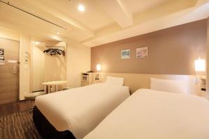 Postel nebo postele na pokoji v ubytování Via Inn Akihabara + 29 fotografií
