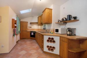 a kitchen with wooden cabinets and a counter top at Ferienwohnung Alpenrose in Bad Reichenhall