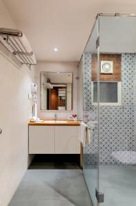 a bathroom with a sink and a shower at The Ramvilas - A Rooftop Pichola Lake View Hotel in Udaipur
