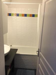 La salle de bains est pourvue d'une baignoire et d'un lavabo. dans l'établissement Appartement bonascre, à Ax-les-Thermes