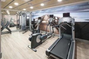 a gym with a wall mural of a pier at Catalonia Diagonal Centro in Barcelona