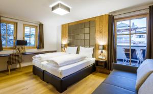Łóżko lub łóżka w pokoju w obiekcie Bolodges Apartments by Alpin Rentals