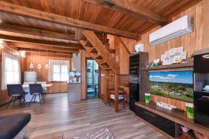 a living room with wooden walls and wooden flooring at Holiday house Kontesa in Veliko Trgovišće