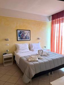 Postel nebo postele na pokoji v ubytování Hotel Naica