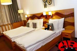 Postel nebo postele na pokoji v ubytování Danubia Gate Hotel