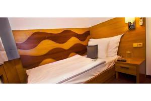 Postel nebo postele na pokoji v ubytování Danubia Gate Hotel