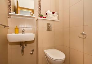 a small bathroom with a toilet and a sink at House Miho in Omiš +36 photos