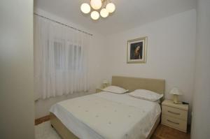 Posteľ alebo postele v izbe v ubytovaní Apartments Ivica